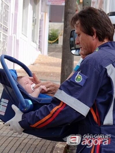 Funcionário do SAMU presta atendimento ao bebê envolvido no acidente. (foto Luciano Lopes). - 