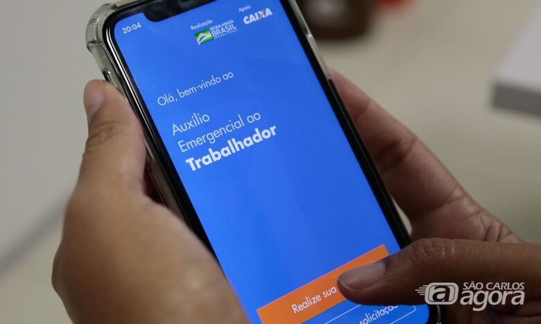 Aplicativo da Caixa permite pagamento de compras em lojas físicas com dinheiro do Auxílio Emergencial - Crédito: Agência Brasil